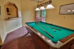 Pool table in basement game room.